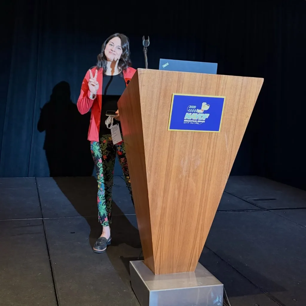 Dr. Gaby at the NAVDF 2026 lecture podium in Indianapolis, ready to present on anesthesia for dermatology patients